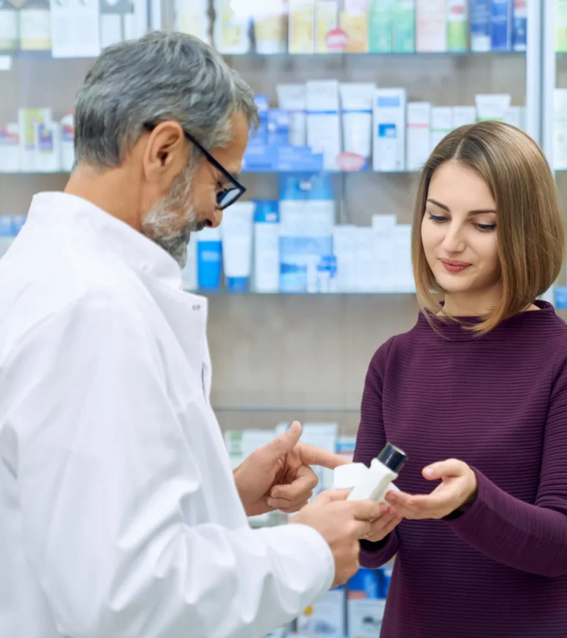 pharmacist-helping-woman-medicine-choice